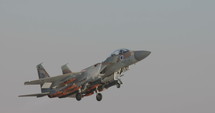 Israeli Air Force F-15 fighter during takeoff armed with bombs and missiles.