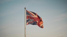Union Jack British Flag blowing in the wind, United Kingdom, national emblem, flagpole