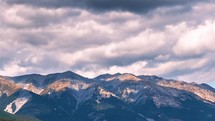 Dramatic gray stormy clouds sky motion fast in alpine mountains in New Zealand nature landscape Time-lapse
