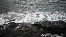 waves crashing into rocks 