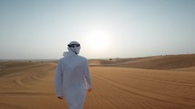 Man Walking Towards The Sun In The Desert 