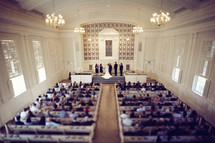 A chapel filled for a wedding ceremony
