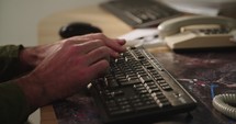 Male hands typing on a computer keyboard and touching the mouse