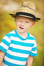 boy in a hat winking 