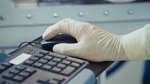 Close up on a worker hand with glove working with a computer mouse