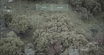Military drone view of soldiers walking through a forest