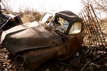 old rusted car in a junk yard