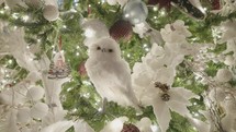 Beautiful Illuminated Christmas Tree Decoration. Snow Balls, Blue Flowers, White Owl and Ice Skates Ornaments. Close Up.	
