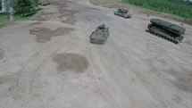 Flying over military vehicles on shooting ground