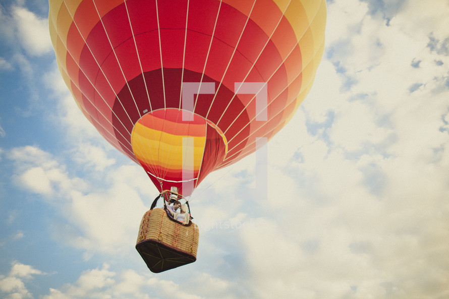 A couple riding in a hot air balloon