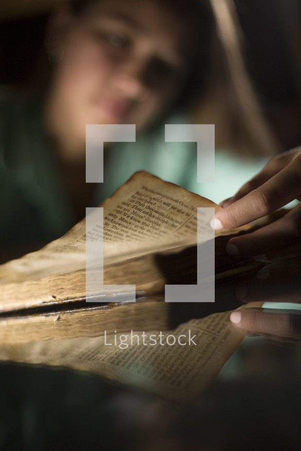 Teen girl reading Bible