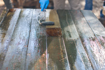 a man staining a table 
