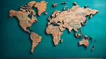 Wooden world map on a teal background. 