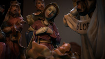 CGI Colorful Christmas Nativity set on coffee table focusing on Baby Jesus and Mary.