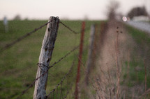 barbed wire on a fence post