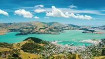 Clouds motion fast over Lyttelton Harbour bay in beautiful New Zealand nature countryside in sunny summer landscape Time lapse

