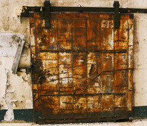 rusted and locked cover over a window