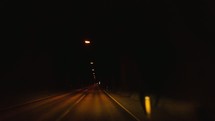 traveling in a car through a tunnel at night 