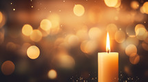 Single candle with bokeh background.