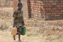 boy child carrying jugs of water