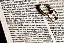 wedding bands on the pages of a Bible