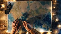 Unrolling old world map in the night 