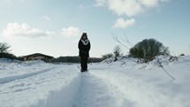 girl slowly walking in the snowy