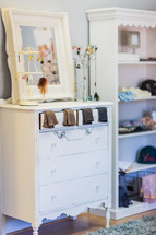 Girl's bedroom with white dresser, jewelry, socks, book shelf mirror