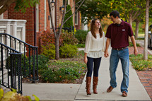 Happy couple walking on sidewalk