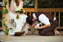 groom washing his brides feet
