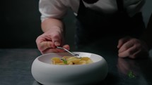 Refining The Plating Of A Ravioli Dish With Flowers