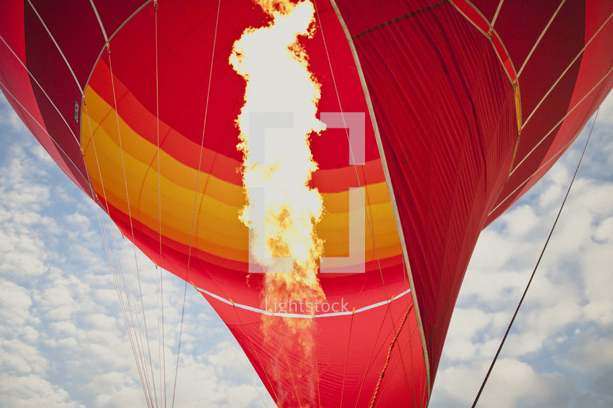 Fire blowing up inside of a hot air balloon