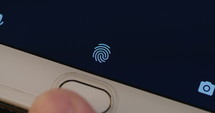 Fingerprint sensor unlocking a smartphone.