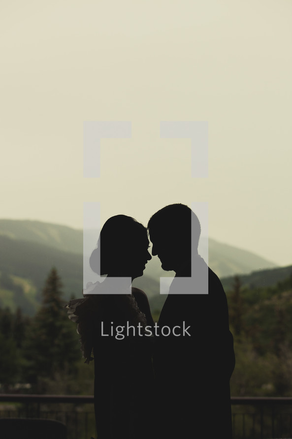 silhouette of a couple about to kiss