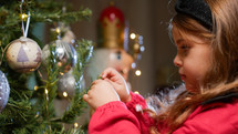 Little Girl decorating Christmas tree