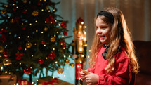 Little girl smiling under the Christmas tree