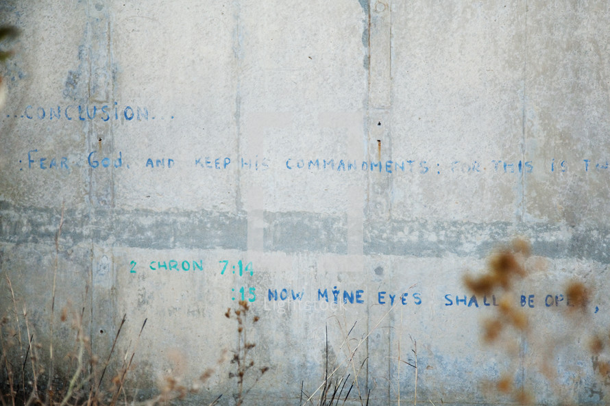 words "Fear God and Keep his commandments" graffiti on a concrete wall