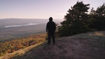 Unrecognizable Man with Black Jacket Standing on the Mountain Peak Facing to the Valley of Autumn Fall Foliage Trees Arkansas for Inspiration