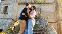 Couple love and kiss on the stairs of a castle during valentines day