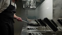Chef Turning On The Stove Under The Pan