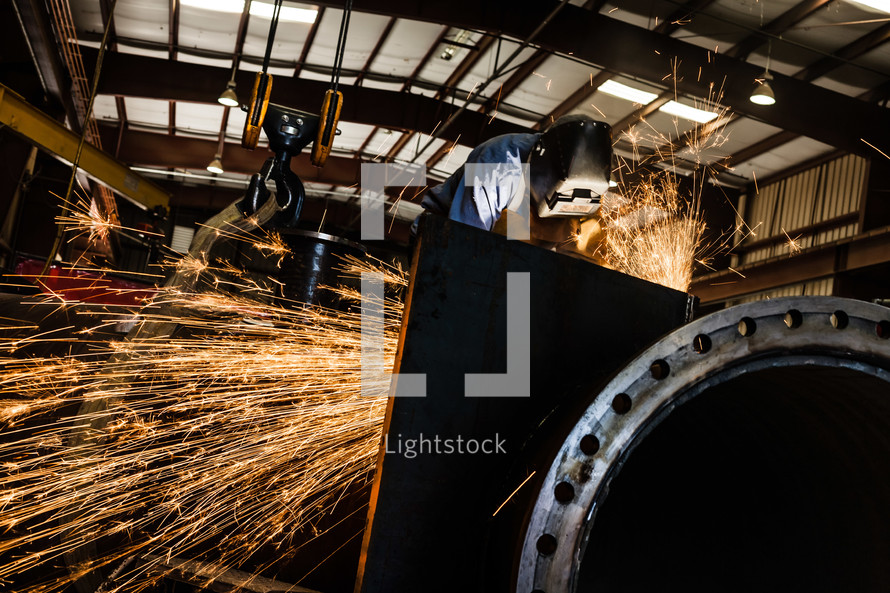 Sparks from a Man welding welder hood steel industrial