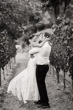 Bride and groom kissing outdoors in a vineyard embrace, love romance wedding napa valley