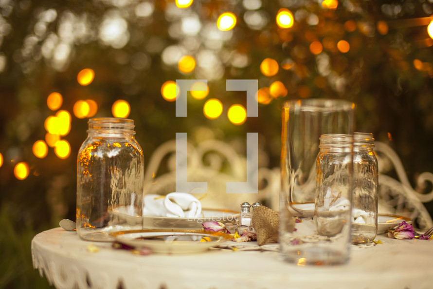 outdoor table with jars and vases