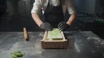 Chef Transforming The Green Dough Into Spaghetti