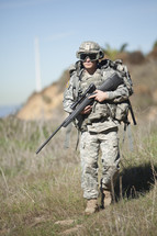 soldier walking carrying a rifle