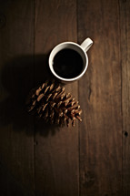 coffee cup and pine cone