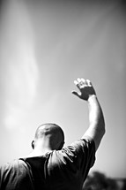 A man raising his hand in prayer