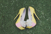 pair of yellow stilettos in the grass