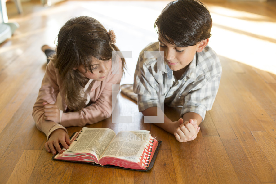 Siblings reading the Bible together