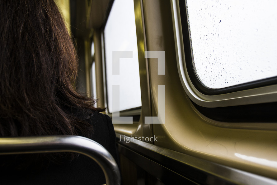 woman sitting on a subway train